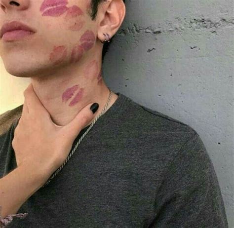 A Man With Pink Lipstick On His Face And Neck Is Standing Next To A Wall