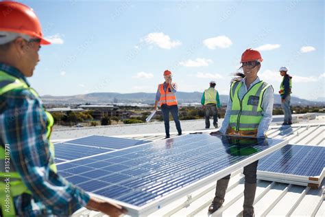 Engineers Lifting Solar Panel At Sunny Power Plant Stock Photo Adobe