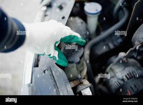 Checking The Level Of Antifreeze In The Coolant In The Car High