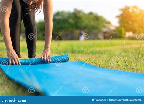 Young Asian Woman Rolling Blue Yoga Mat Or Fitness Mat Prepare To