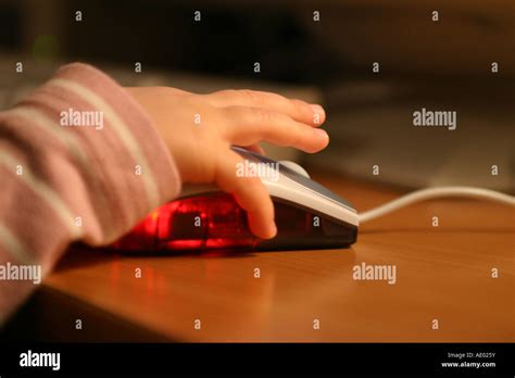 Childs Hand On A Computer Mouse Stock Photo Alamy