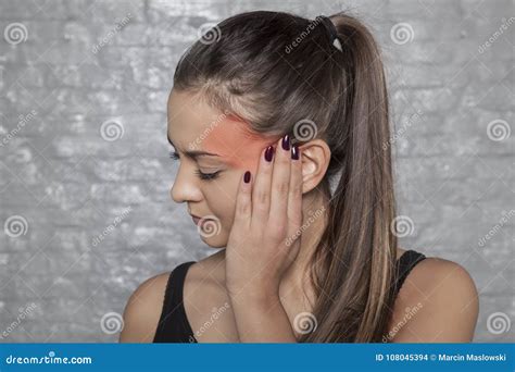 Woman With A Headache Holding Her Head Pain Area Marked In Red Stock