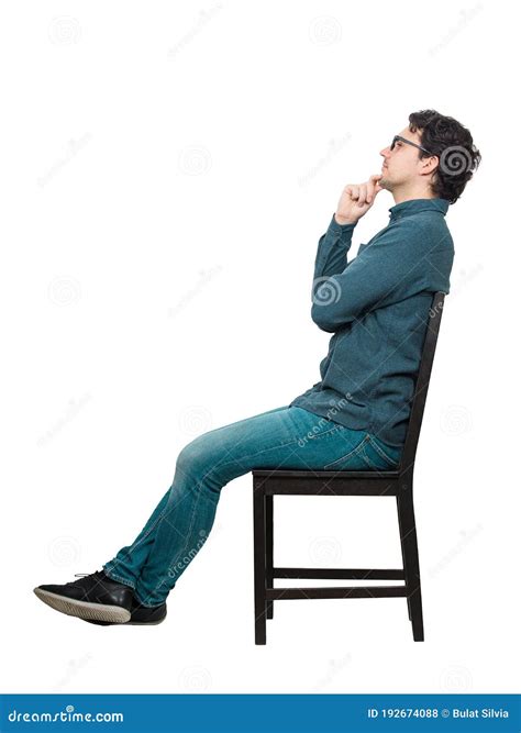 Side View Full Length Young Businessman Sitting On Chair Keeps Hand