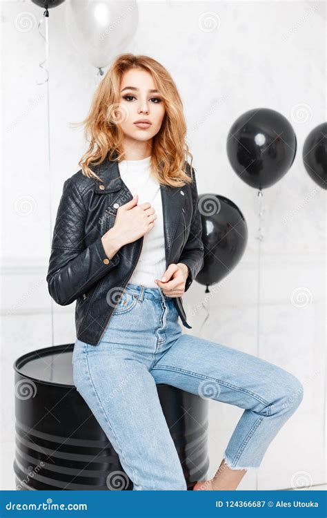 Beautiful Young Girl In A Black Leather Jacket And Blue Jeans Stock