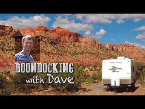 A Man Is Standing In Front Of A Trailer With The Words Boondocking With