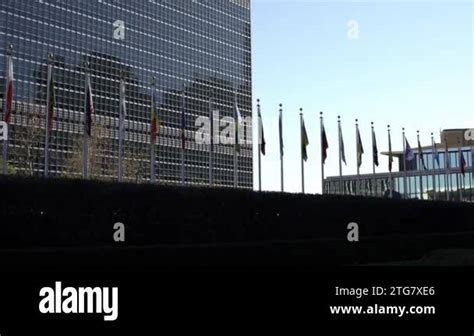 Multiple flags in front of the United Nations headquarters in New York ...