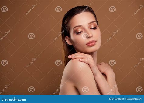 Photo Of Pretty Shiny Woman Nude Shoulders Cuddling Herself Empty Space Isolated Beige Color