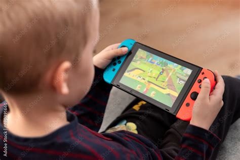 Boy plays Nintendo Switch console Stock Photo | Adobe Stock