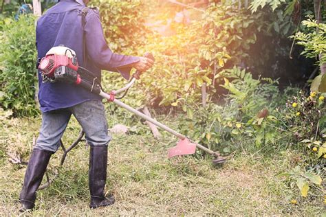 Selective Focus Of The Farmers Are Using A Cutting Machine To Cut Weeds In Desolate Farms