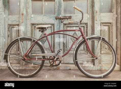 Vintage beach cruiser bicycle in front of antique wooden weathered ...