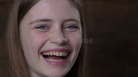 Portrait Of A Beautiful Happy Girl With Blond Hair And Freckles Looking