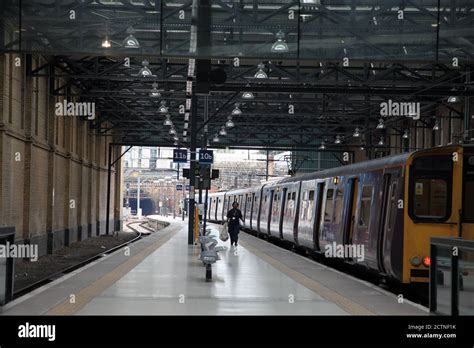 Train Cleaner Walking Along Deserted Platforms At Kings Cross Station