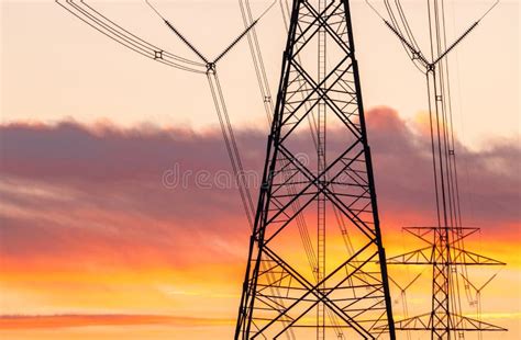 High Voltage Electric Pole And Transmission Lines In The Evening