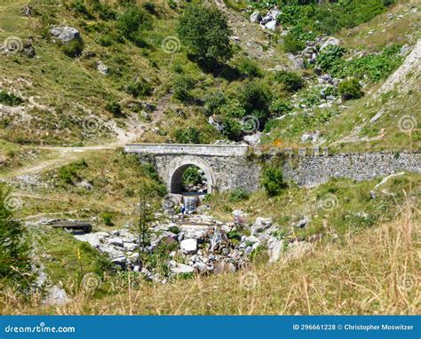 Castelmagno Small Stone Bridge With Mountain Landscape Of Cottian