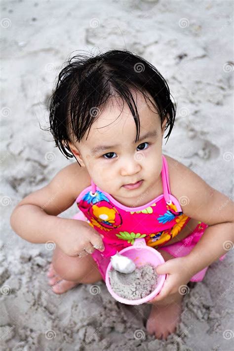 Asian Little Chinese Girl Playing Sand With Beach Toys Stock Photo