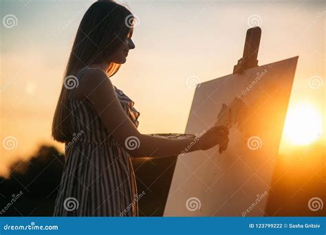 Silhouette Of A Blonde Girl Artist Lady Paints A Painting On The