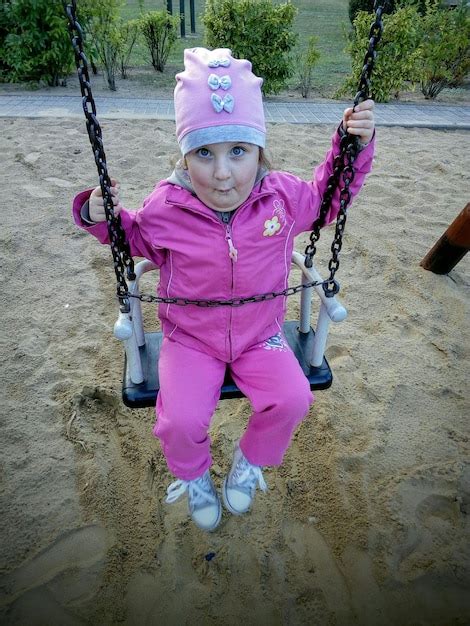 Premium Photo Close Up Of Portrait Of Girl Sitting On Swing