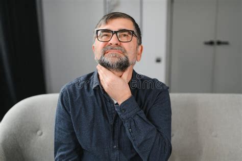 Illness And Disease Concept Sick Mature Aged Man Feeling Sore Throat With Painful Swallow Stock