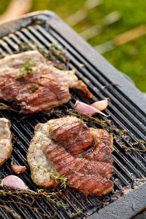 Grilled Pork Neck with Herbs and Garlic on a Cast Iron Grill Plate ...