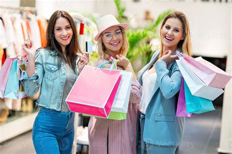 Picture Of Group Of Happy Friends Shopping For Clothes In Mall 15766381