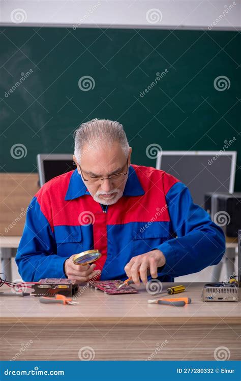 Old Repairman Repairing Computers In The Classroom Stock Photo Image