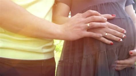 Mom And Dad Hands On Pregnant Tummy Showing Heart Sign Pregnant Couple