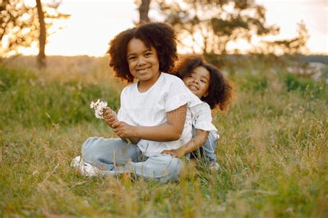 Two African American Sister Embracing In A Park Stock Image Image Of