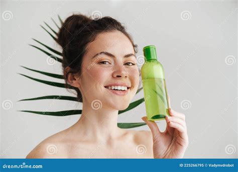 Half Naked Brunette Woman Smiling While Showing Facial Lotion Stock