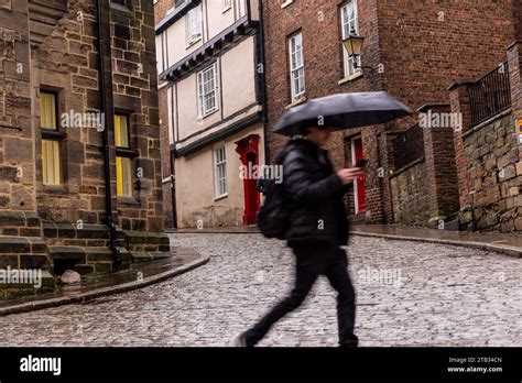 Durham Uk 04 Dec 2023 Uk Weather Person With An Umbrella Passes The