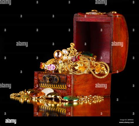 Wooden Chest Full Of Gold Jewelry On Black Background Stock Photo Alamy