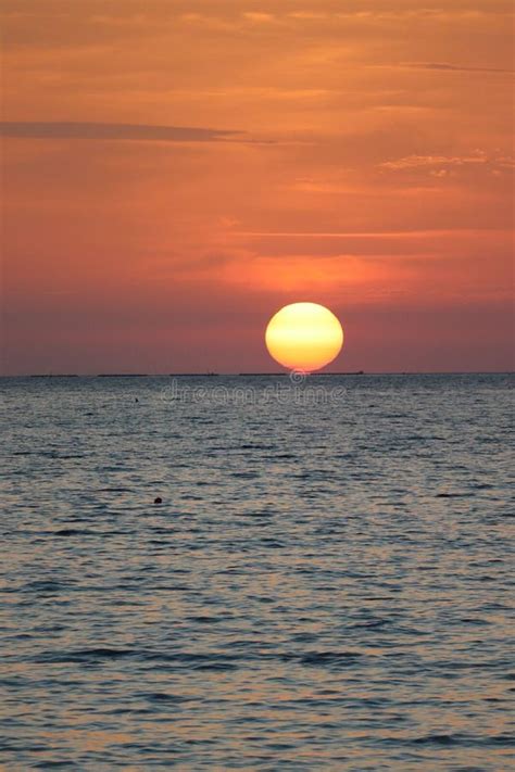 Vertical Shot of the Sun Going Down Over the Ocean Stock Photo - Image ...