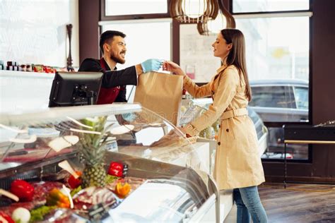 Shop Assistant Handling Shopping Bag To Female Customer In Grocery Store Stock Image Image Of