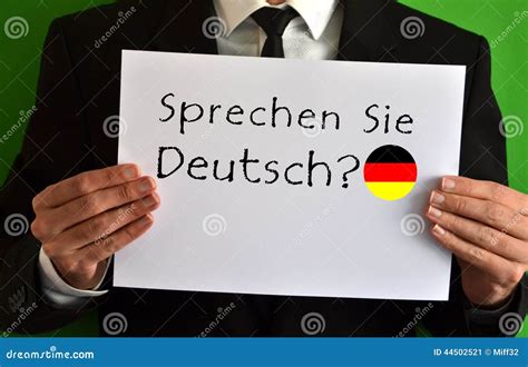 Businessman Showing A Sheet With Text Sprechen Sie Deutsch Stock Image