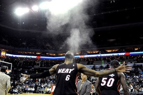 Miami Heat forward LeBron James (6) throws talcum powder in the air ...