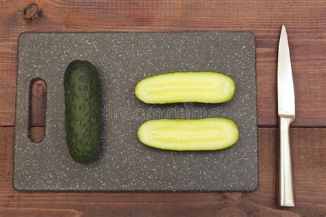 Sliced Fresh Cucumber On Cutting Board On Wooden Table View From Above