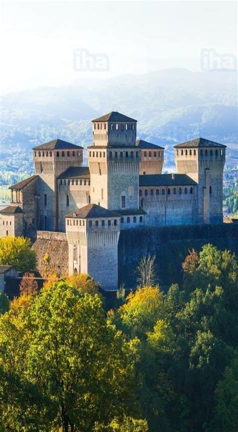 An Old Castle On Top Of A Hill Surrounded By Trees