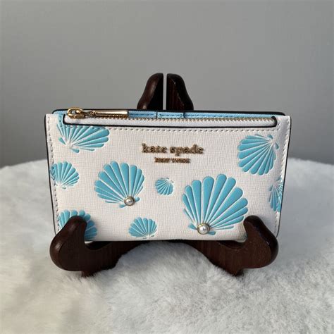 NWT Kate Spade Morgan Seashell Printed Slim Bifold Leather Wallet Cream