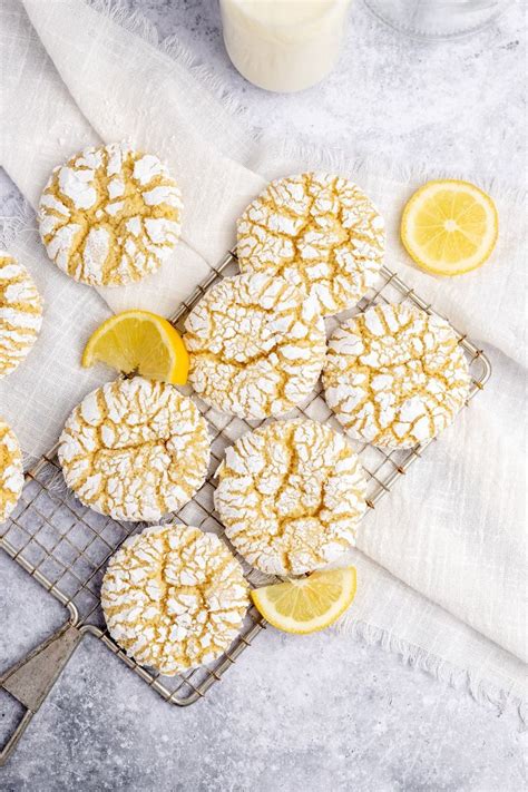 Lemon Crinkle Cookies On A Cooling Rack Next To A Glass Of Milk