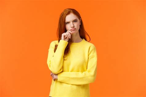 Premium Photo Skeptical And Unsure Redhead Focused Serious Looking Female Taking Hard