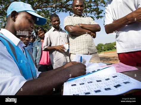 A Worker From The Ghana Electoral Commission Checks The Identity Of A