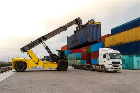 Premium Photo | Truck while loading in logistic shipping yard with cargo container Forklift ...