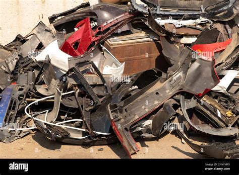 Broken Bumpers And Parts Of Cars On The Street Like Garbage Stock Photo