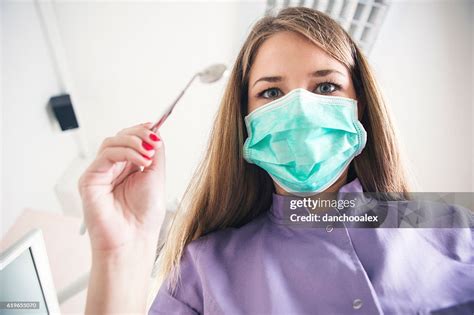 Female Dentist Holding Dental Tool High Res Stock Photo Getty Images