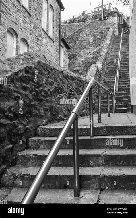 Black And White Image Of Very Old Flight Of Steep Worn Stone Steps In