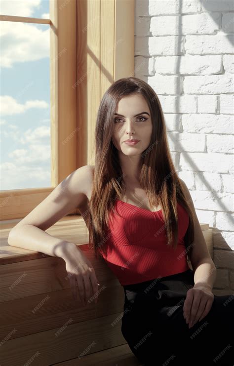 Premium Photo Vertical Portrait Of Pretty Brunette Sitting On Window