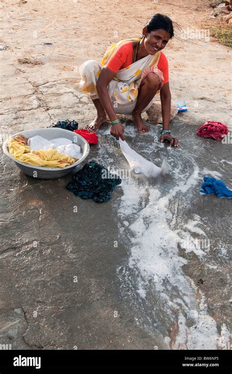 Indian Woman Washing Clothes By Hand Next To A River Andhra Pradesh