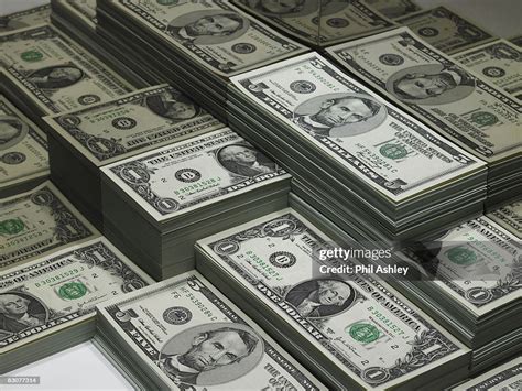 Piles Of Dollar Bills Reflected In Glass High Res Stock Photo Getty