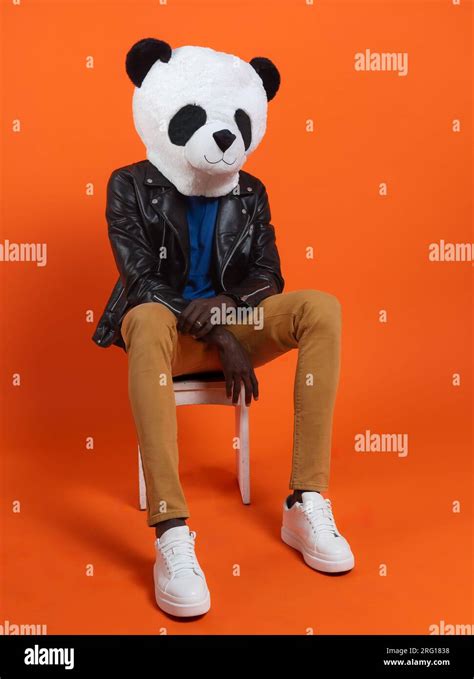 Faceless black person wearing panda mask, black leather jacket and ...