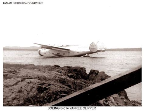 An Airplane Is On The Water Near Some Rocks