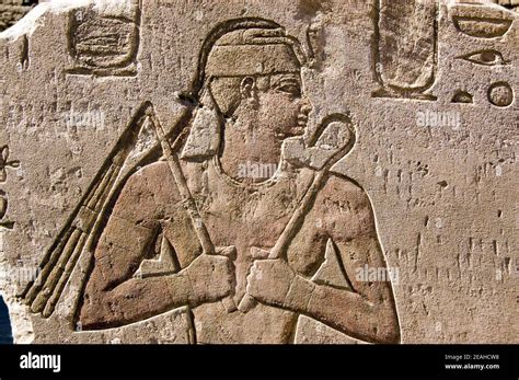 Ancient Egyptian Hieroglyphic Carving Of A Pharaoh Holding A Flail Or